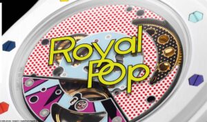 Close-up of a colorful wristwatch movement with a red polka-dot background and bold yellow text reading 'Royal Pop' across the face.